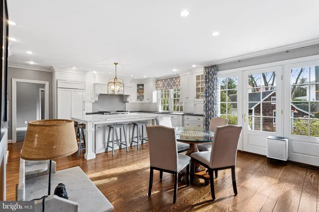 a dining room with furniture and a floor to ceiling window