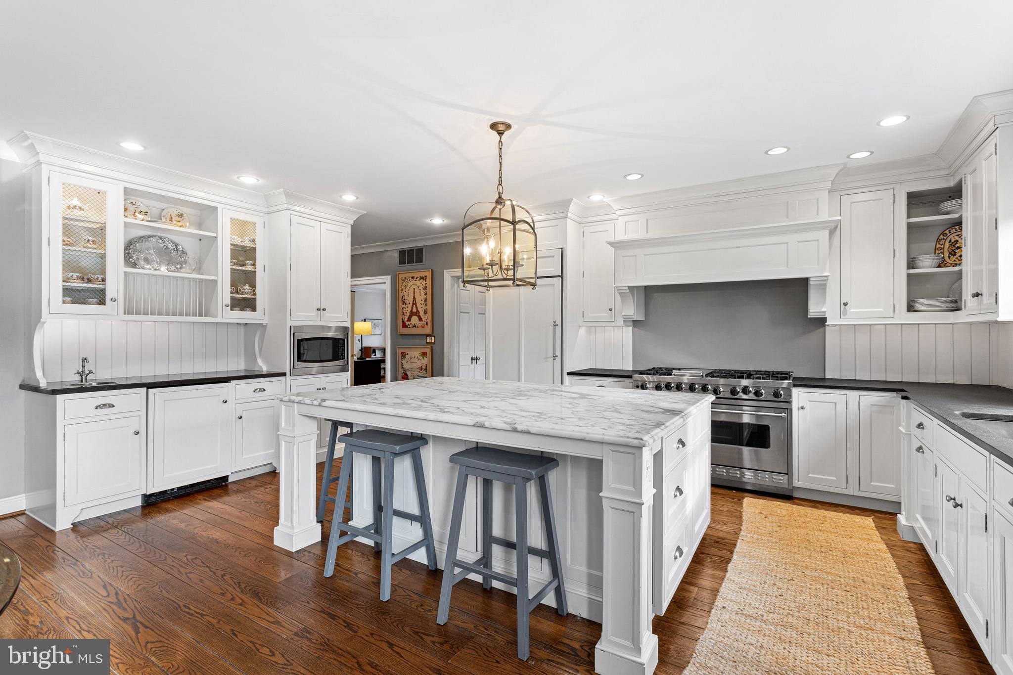 370 Station Avenue Haddonfield, NJ 08033 - Photo 9 of 48 a kitchen with stainless steel appliances granite countertop a stove top oven a sink dishwasher and a refrigerator with wooden floor