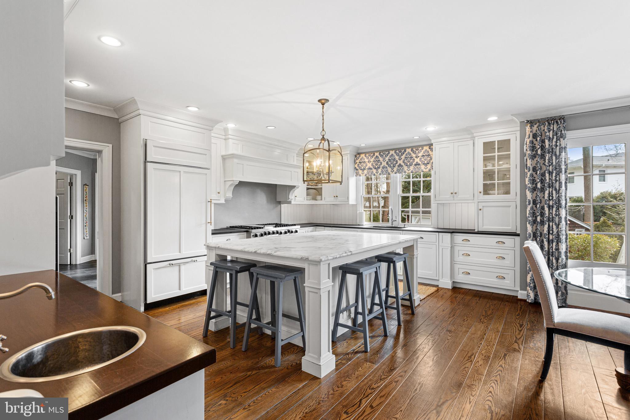370 Station Avenue Haddonfield, NJ 08033 - Photo 10 of 48 a kitchen with stainless steel appliances granite countertop a stove a refrigerator a kitchen island a stove and a wooden floors