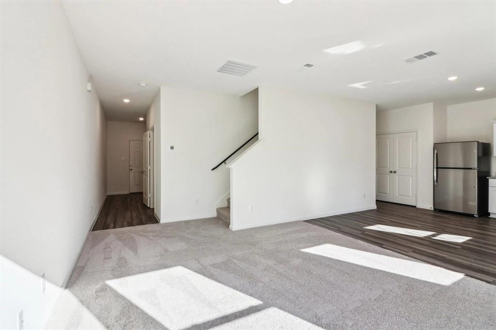 14126 Donahue Street Pilot Point, TX 76258 - Photo 13 of 21 a view of a hallway with a refrigerator