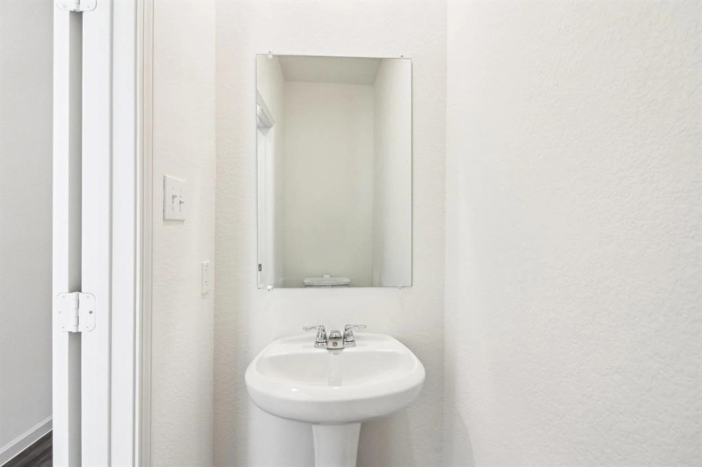 14126 Donahue Street Pilot Point, TX 76258 - Photo 14 of 21 a bathroom with a sink and a mirror