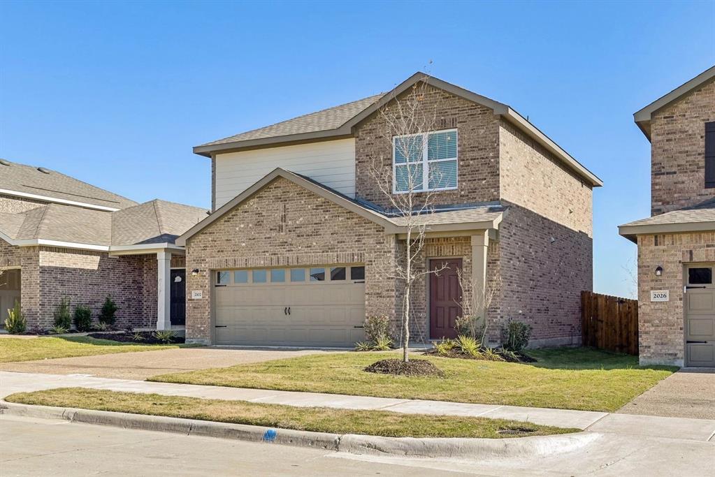 14126 Donahue Street Pilot Point, TX 76258 - Photo 2 of 21 a view of a house with a yard and garage