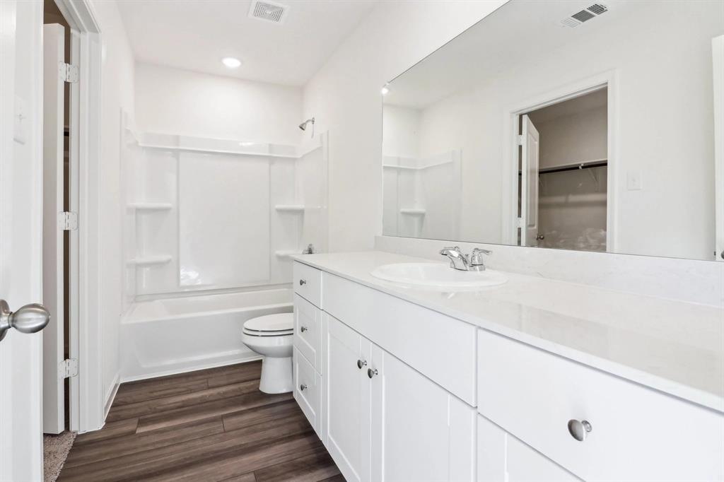 14126 Donahue Street Pilot Point, TX 76258 - Photo 21 of 21 a spacious bathroom with a double vanity sink toilet and shower