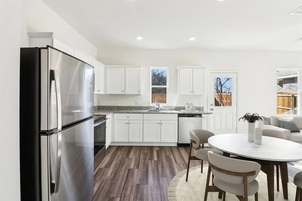 14126 Donahue Street Pilot Point, TX 76258 - Photo 5 of 21 a kitchen with a refrigerator a sink and chairs