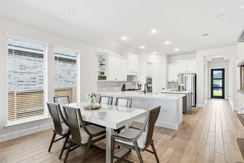 a dining room with furniture and wooden floor