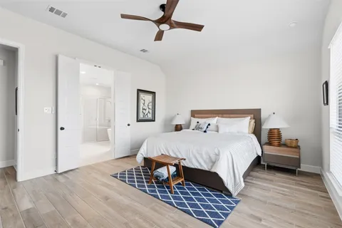 a bedroom with a bed and wooden floor