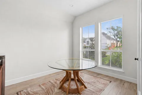 a room with wooden floor and a table