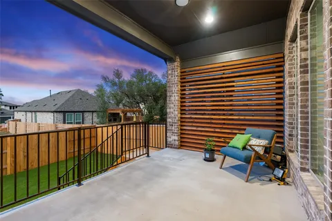 a view of a patio with a table and chairs