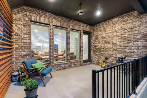 a balcony with furniture and a potted plant