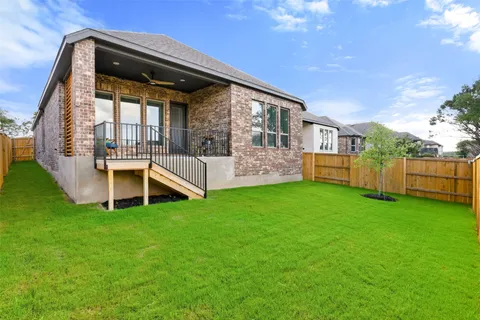 a view of a house with backyard and porch