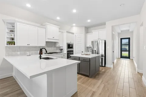 a kitchen with a sink stove and cabinets