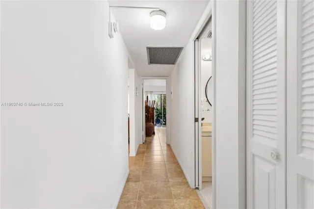 a view of a hallway with a white walls and stairs