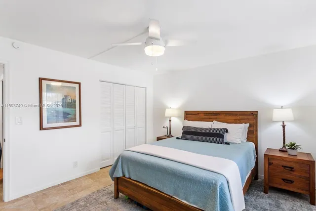 a bedroom with a bed and a night stand