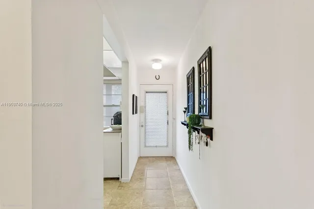 a view of a hallway with wooden shelves