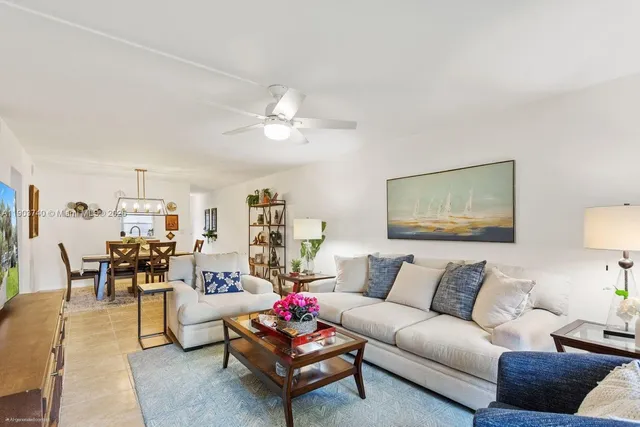 a living room with furniture and a dining table with wooden floor