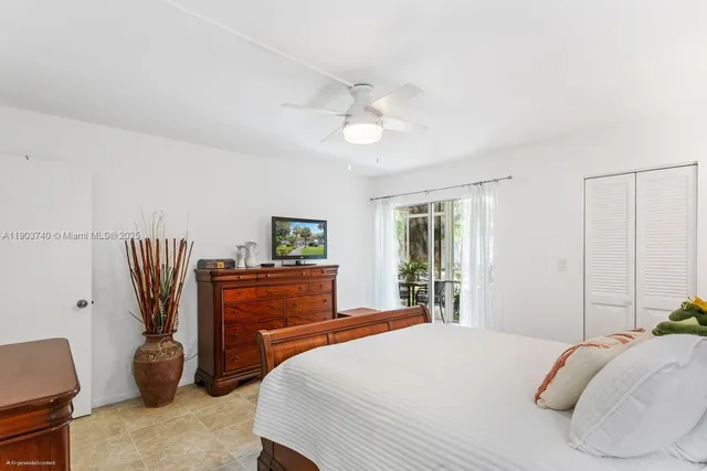 a bedroom with a bed closet and a window