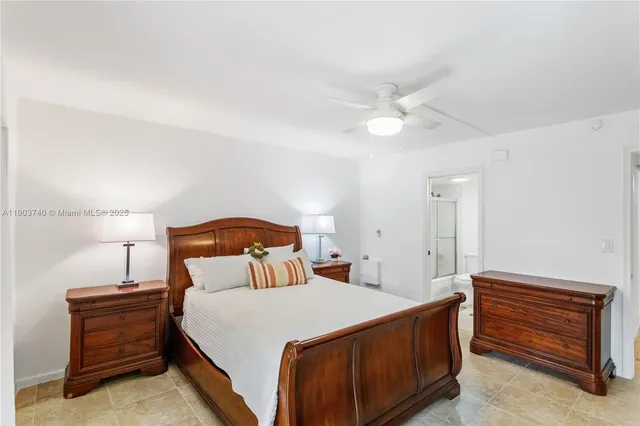 a bedroom with a bed and a ceiling fan