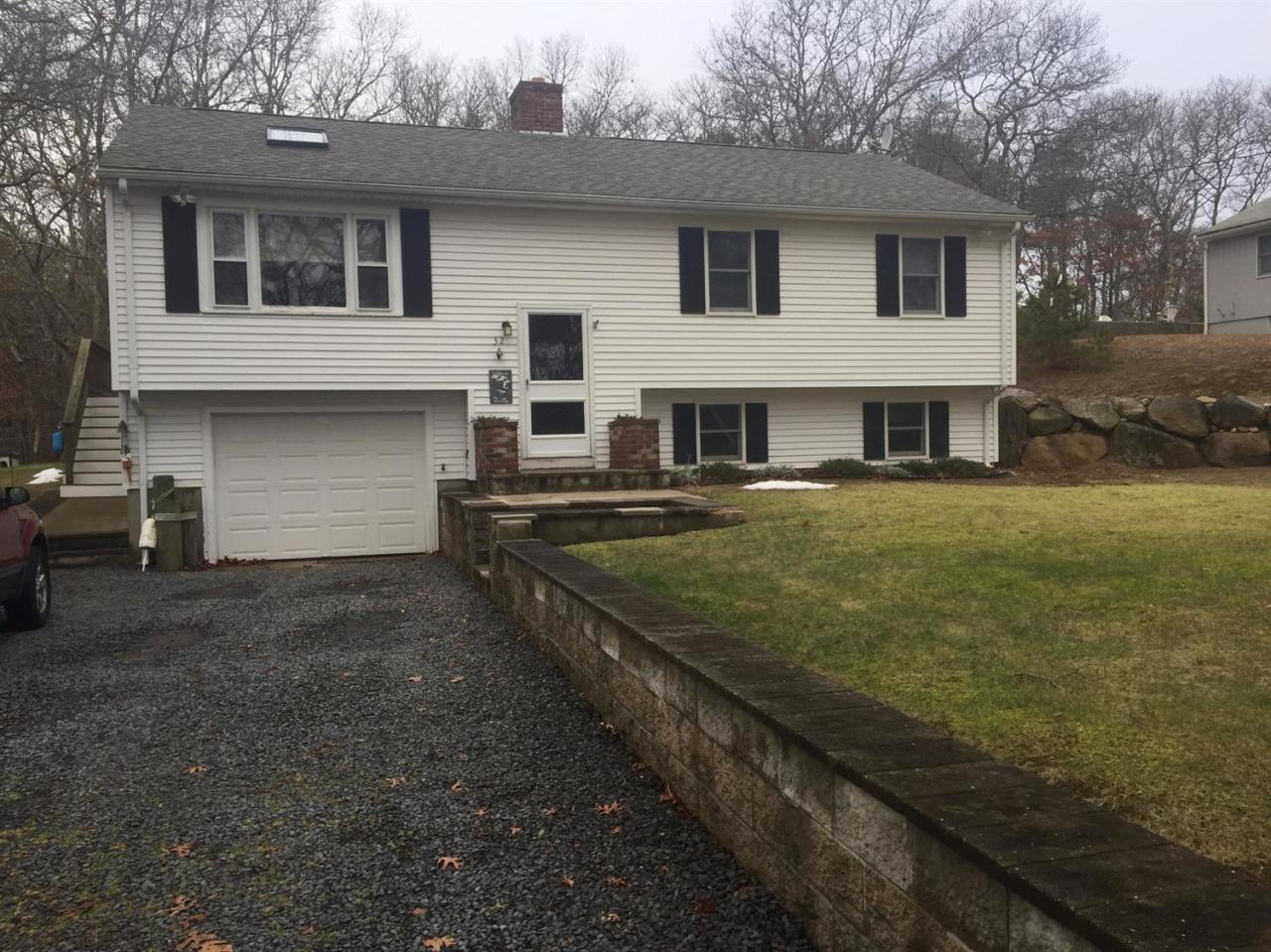 32 Foster Howard Road Pocasset, MA 02559 - Photo 1 of 13 a view of a white house with large windows