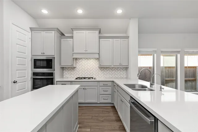 a kitchen with granite countertop white cabinets and white appliances