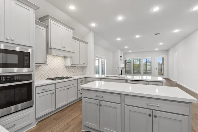 a kitchen with a sink stove and cabinets
