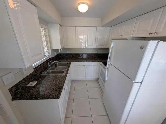 a kitchen with a sink and a refrigerator
