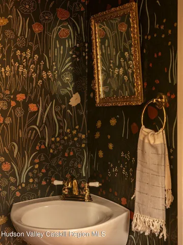 a bathroom with a sink and mirror