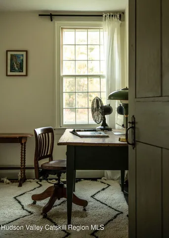 a view of a dining room with furniture large windows and wooden floor