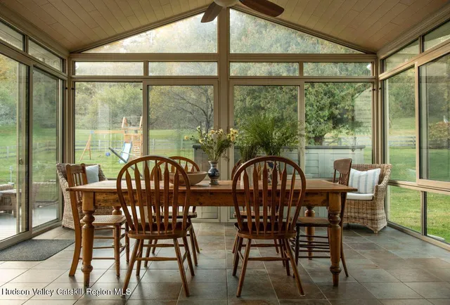 a view of a house with backyard and sitting area