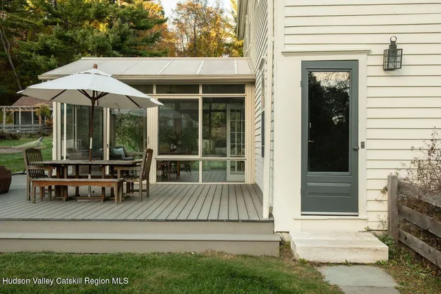 a view of a house with backyard and sitting area