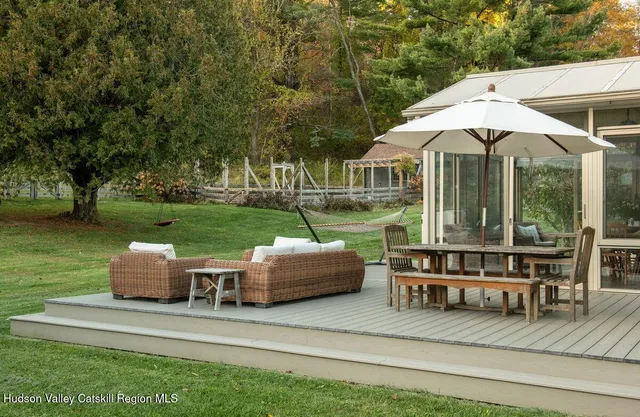 a front view of a house with a yard table and chairs