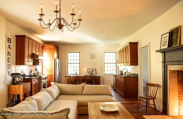 a living room with furniture wooden floor and a chandelier