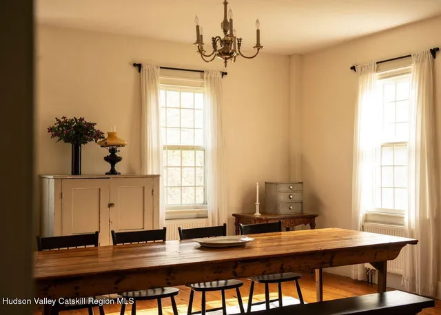 a view of a workspace with furniture and window