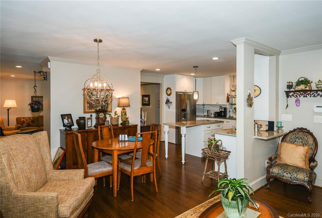 5644 Londonderry Road Charlotte, NC 28210 - Photo 13 of 23 a view of a dining room and livingroom with furniture wooden floor a chandelier