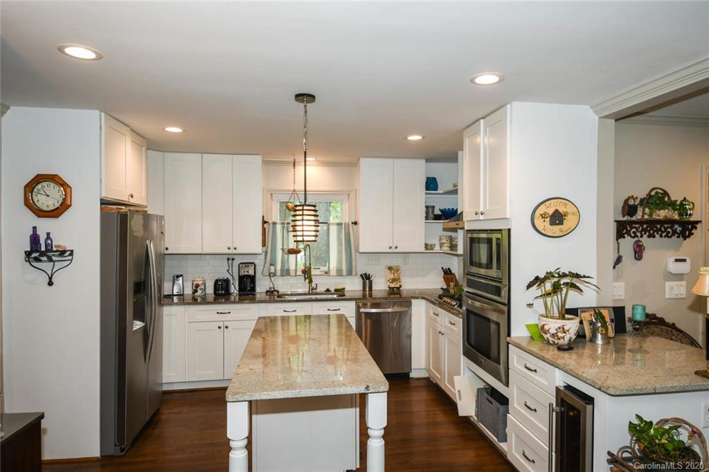 5644 Londonderry Road Charlotte, NC 28210 - Photo 8 of 23 a kitchen with stainless steel appliances kitchen island granite countertop a refrigerator a sink and a stove
