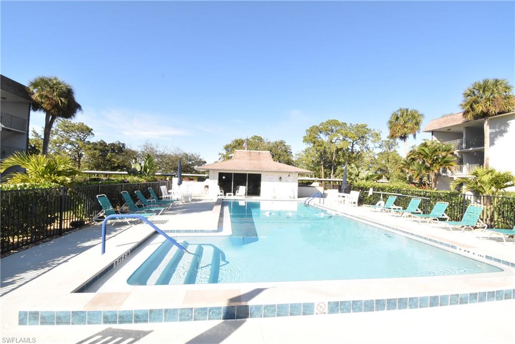5667 Rattlesnake Hammock Road, Unit B205 Naples, FL 34113 - Photo 3 of 16 Community pool with a patio