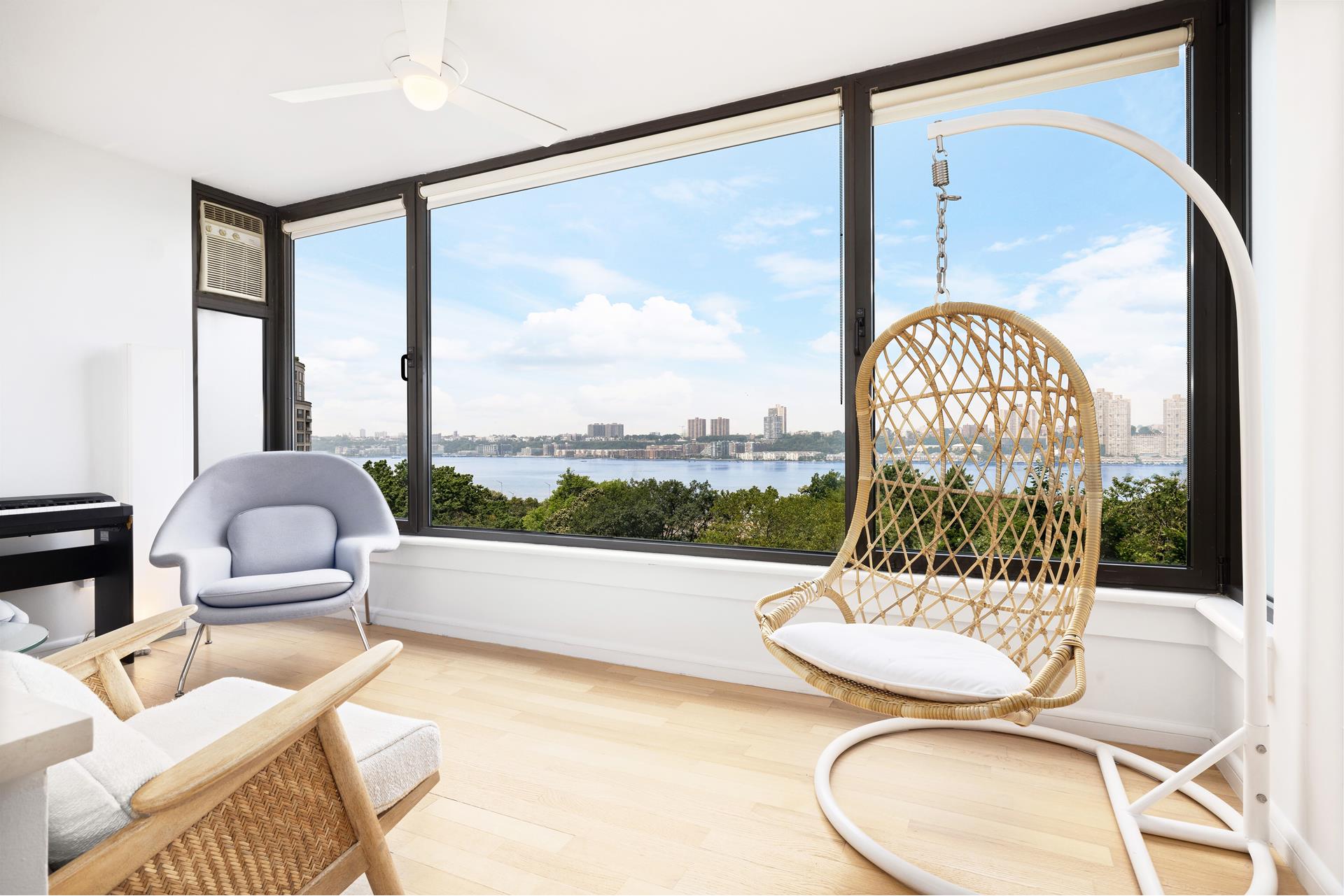 11 Riverside Drive, Unit 8JHW Manhattan, NY 10023 - Photo 1 of 15 a living room with a large glass table and a large window