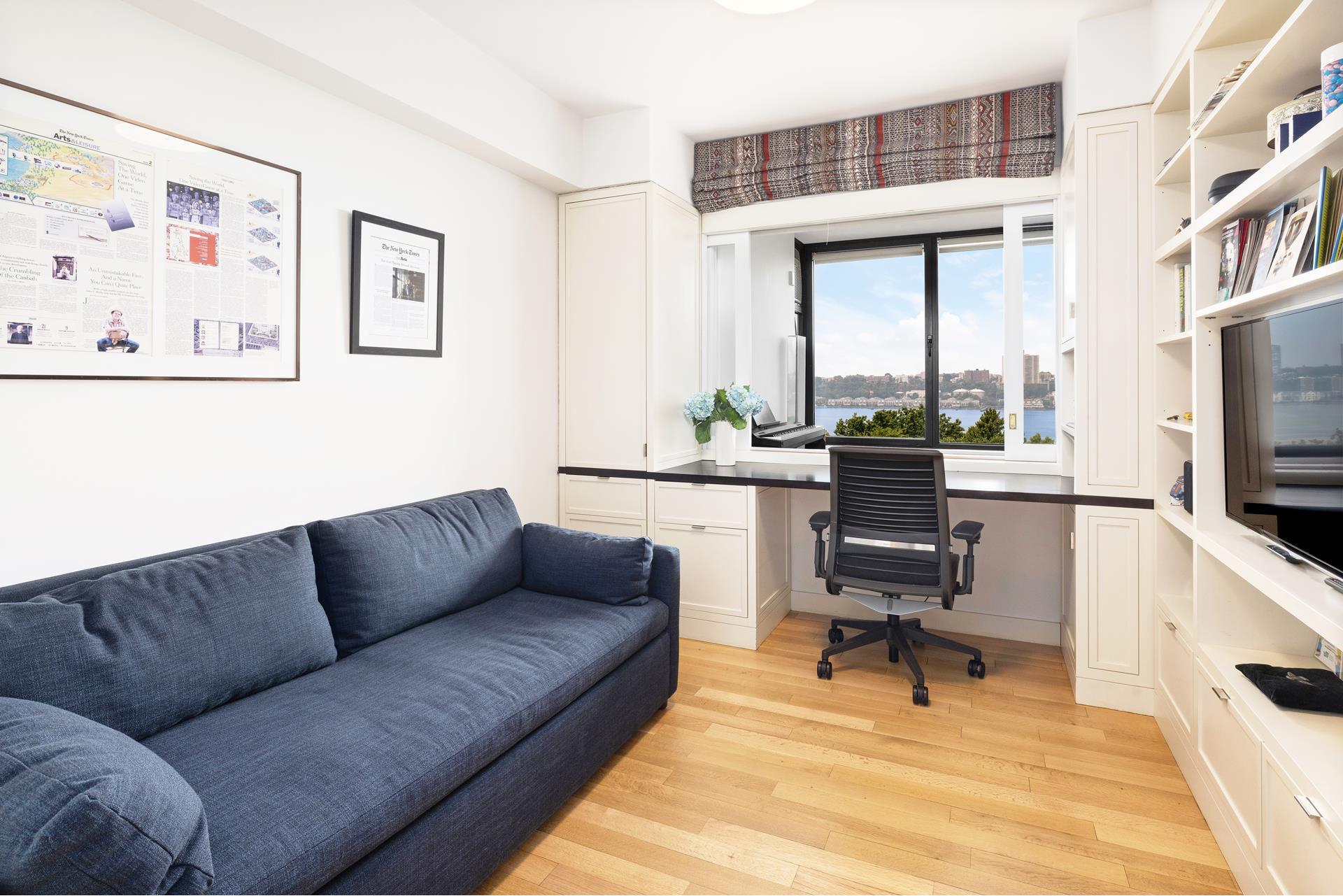 11 Riverside Drive, Unit 8JHW Manhattan, NY 10023 - Photo 5 of 15 a living room with furniture and a flat screen tv