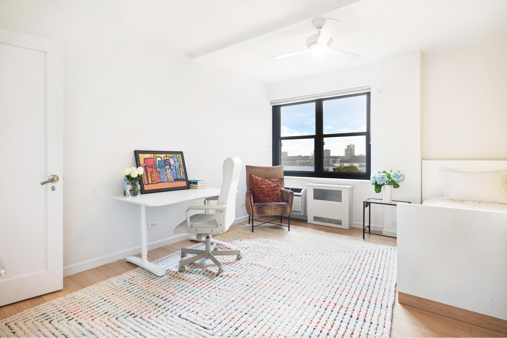 11 Riverside Drive, Unit 8JHW Manhattan, NY 10023 - Photo 9 of 15 a living room with furniture a rug and a window