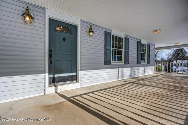a view of a kitchen with wooden floor and a sink
