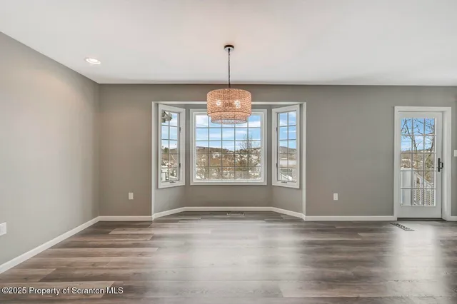 a kitchen with stainless steel appliances granite countertop a sink a stove and refrigerator