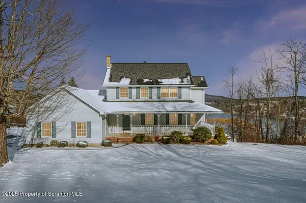 a view of a white house with a yard