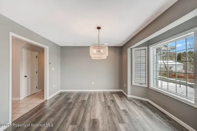 an empty room with furniture and a flat screen tv