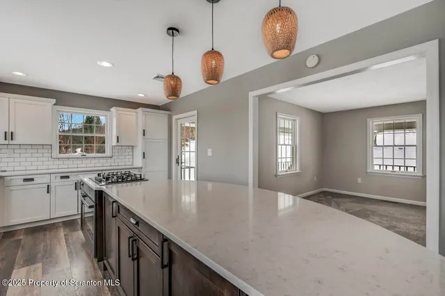 a view of a livingroom with furniture and a fireplace