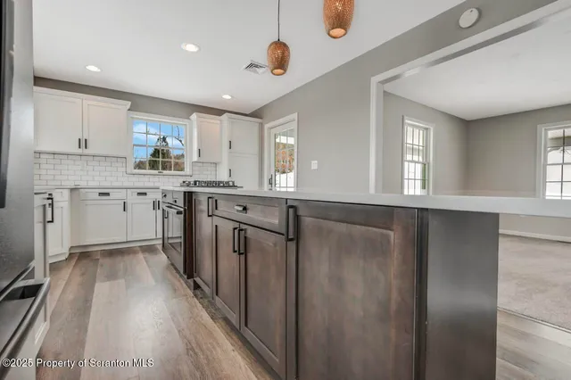 a view of an empty room with windows