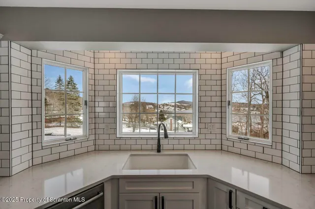 a bathroom with a granite countertop sink a bathtub and shower