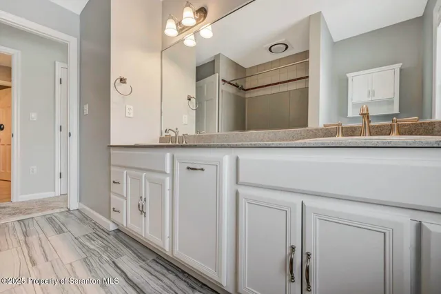 a view of empty room with stairs and wooden floor