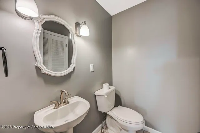 a view of a house with snow on the side of the road