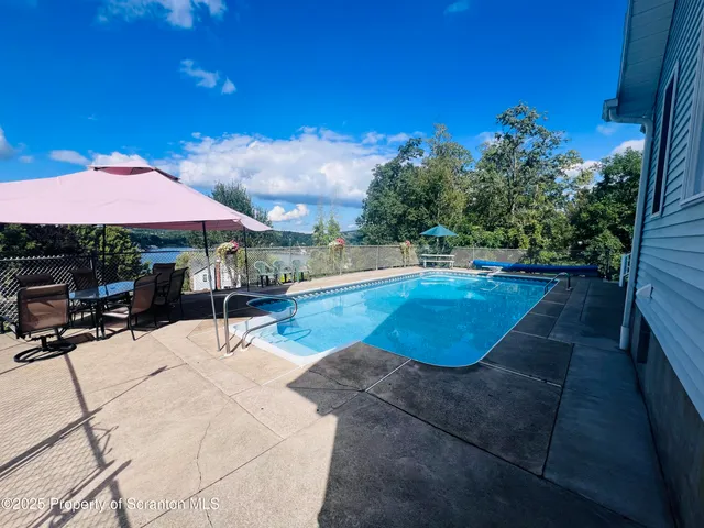 a view of a house with swimming pool and a garden