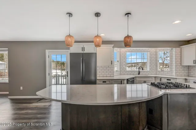 a view of an entryway with wooden floor