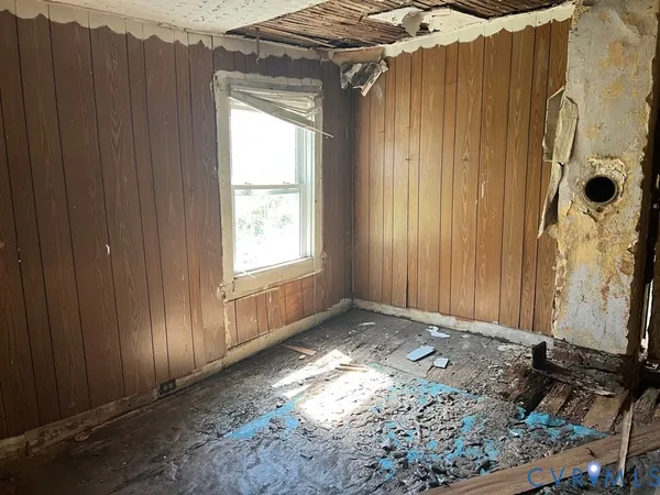 a view of an empty room with wooden door